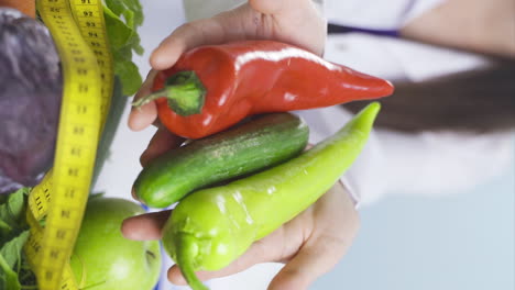 Vertical-video-of-Dietitian-doctor-holding-vegetables.-Healthy-life-message.